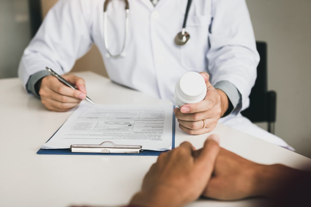 Doctor consulting to patient and talking about medicine.